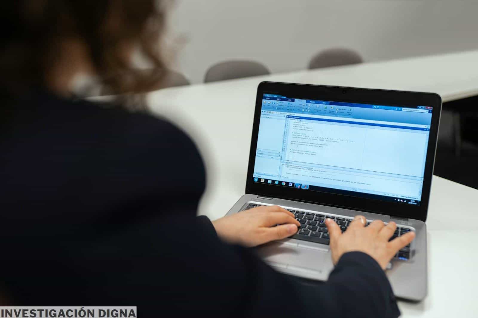 woman in black long sleeve shirt using macbook pro
