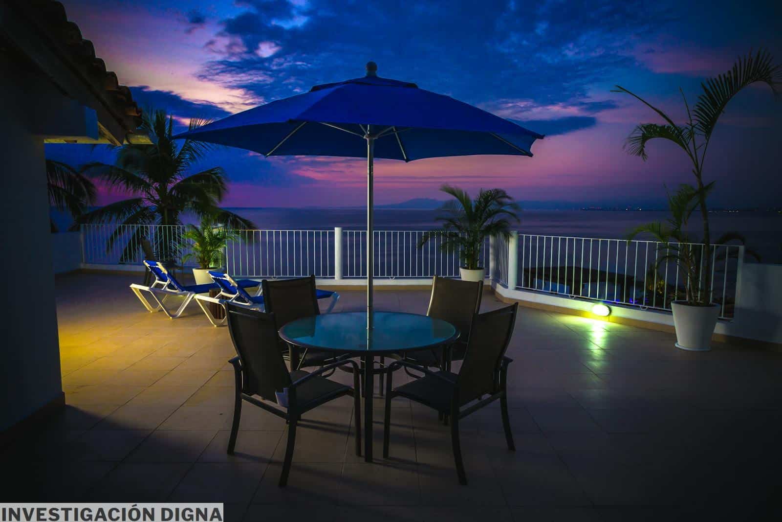 Round Metal Patio Near Railings at Night